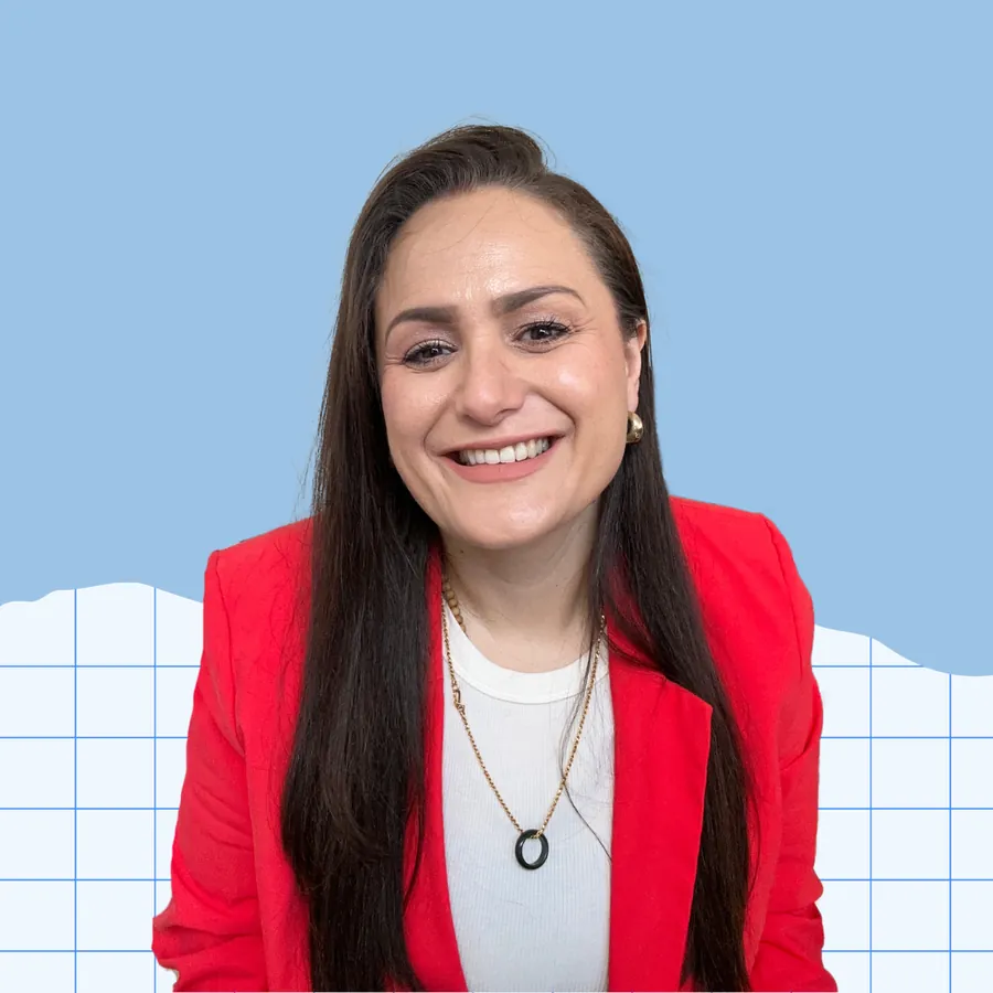Daniellle Bhatt smiling, in a red blazer